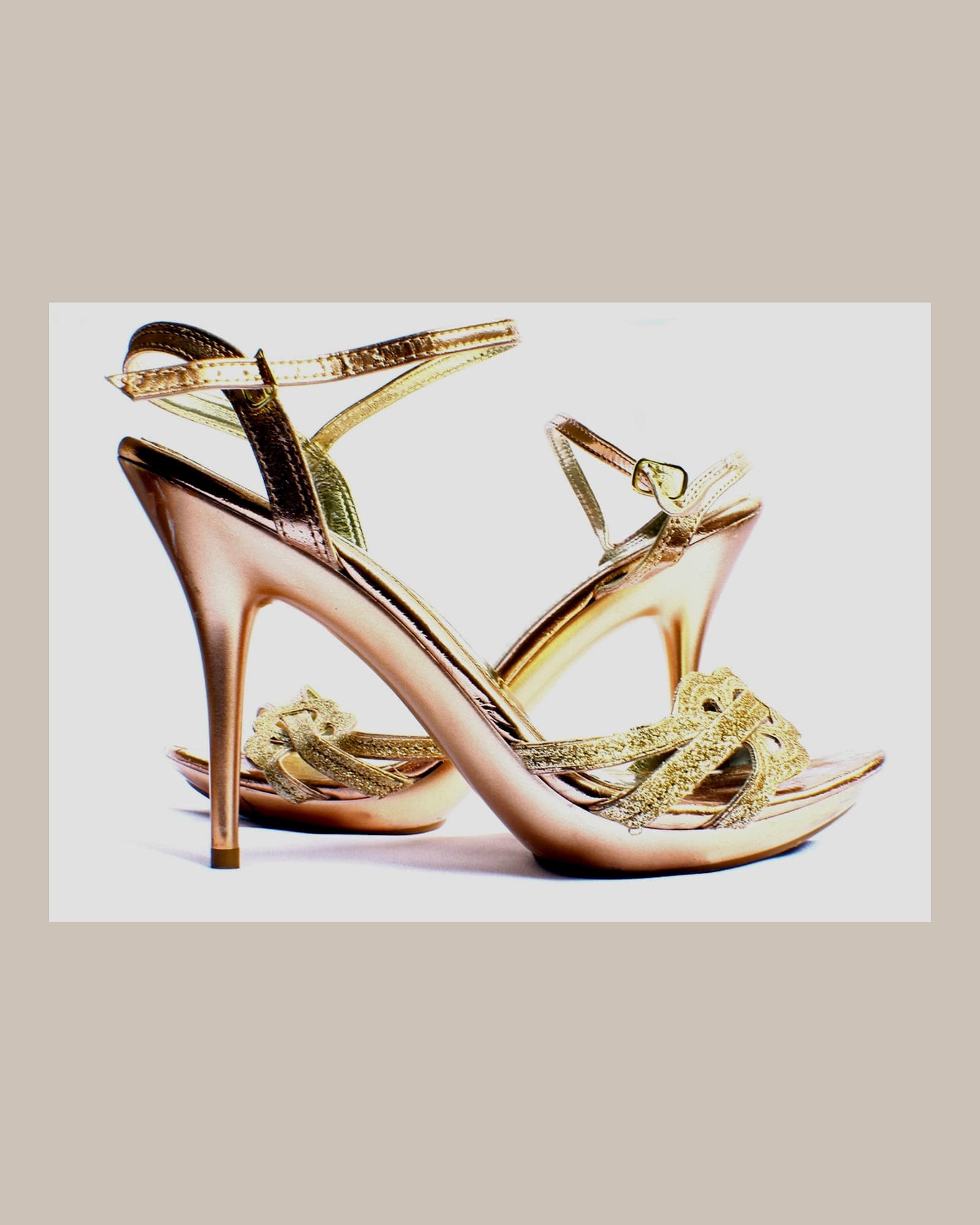 Rose-gold strappy high-heeled sandals, white background