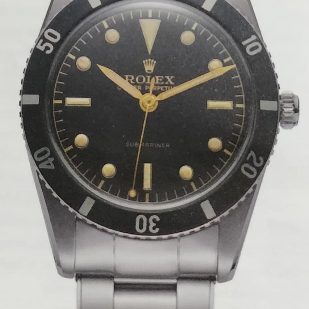 Steel Rolex Submariner with a black bezel and gilt dial