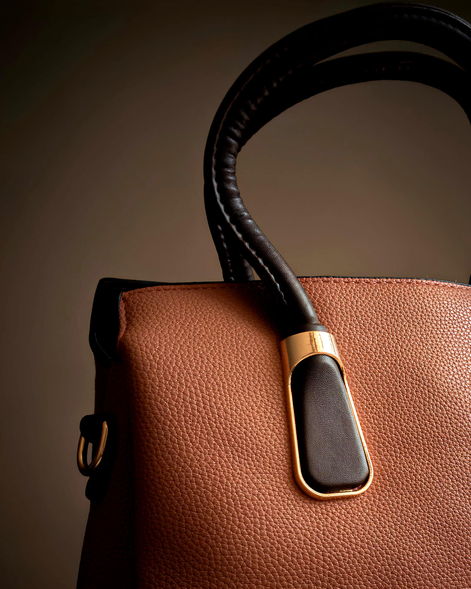 Cognac grained leather bag with a wrapped handle and gold clasp