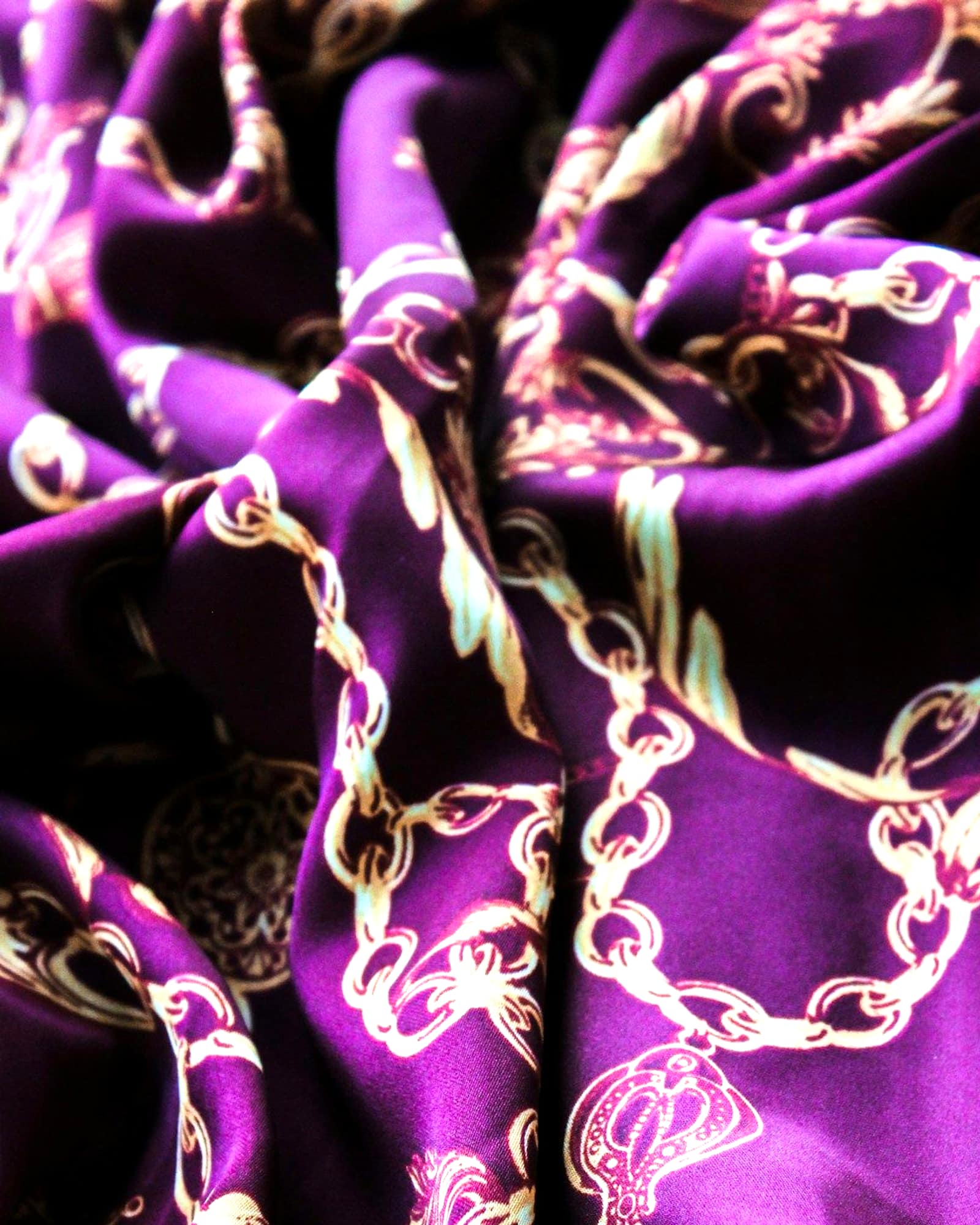 Violet silk scarf printed with ivory chain and shell motifs — detail view