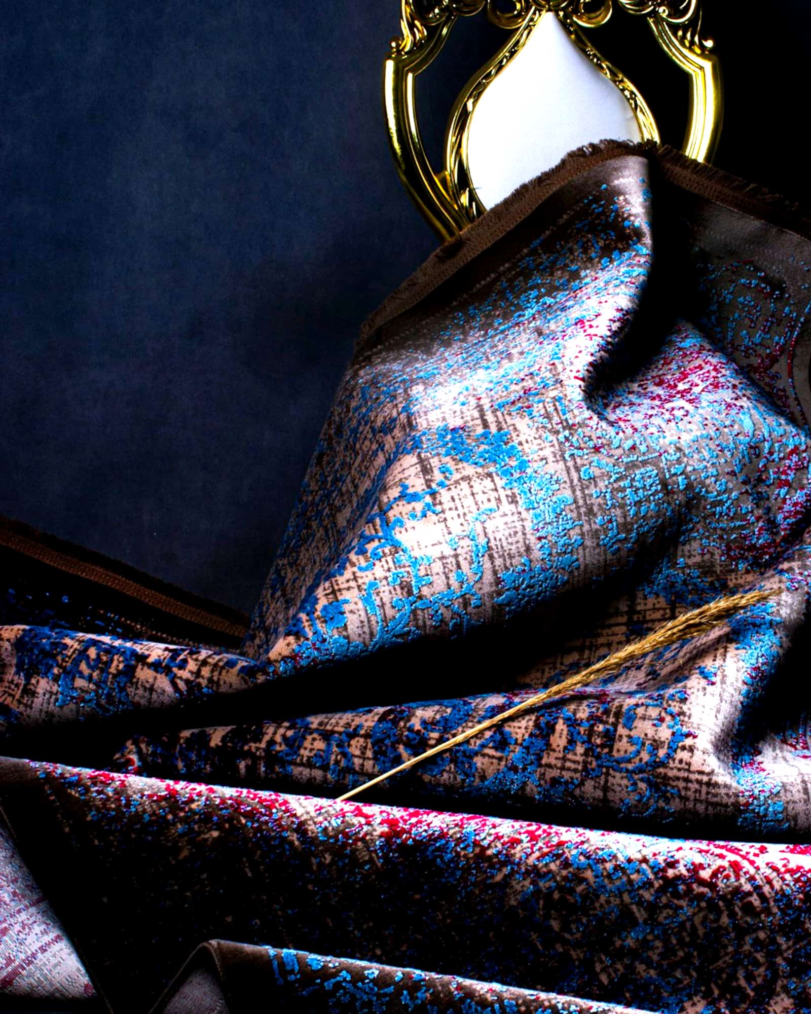 Midnight paisley silk scarf draped beneath a gilt frame — detail view