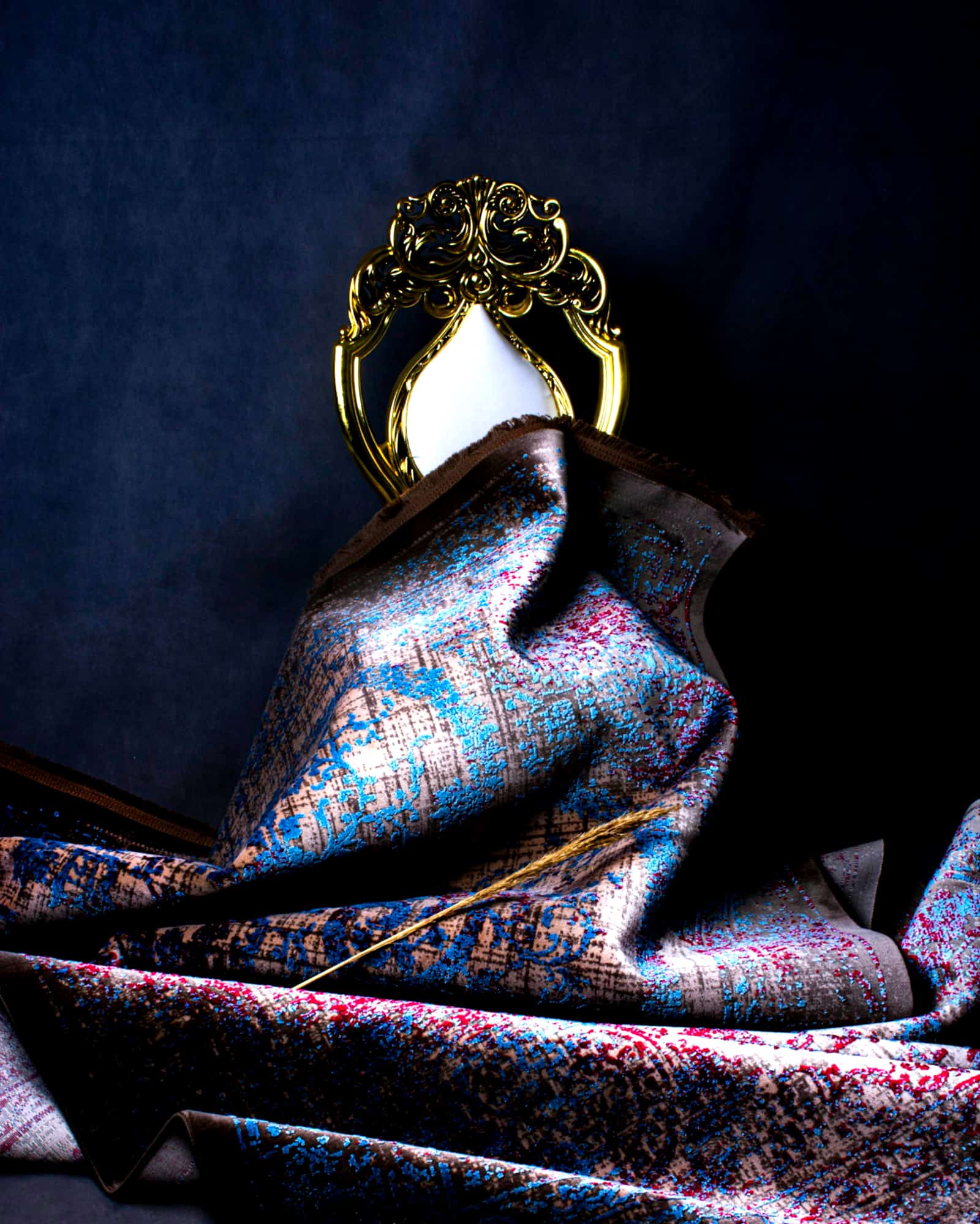 Midnight paisley silk scarf draped beneath a gilt frame