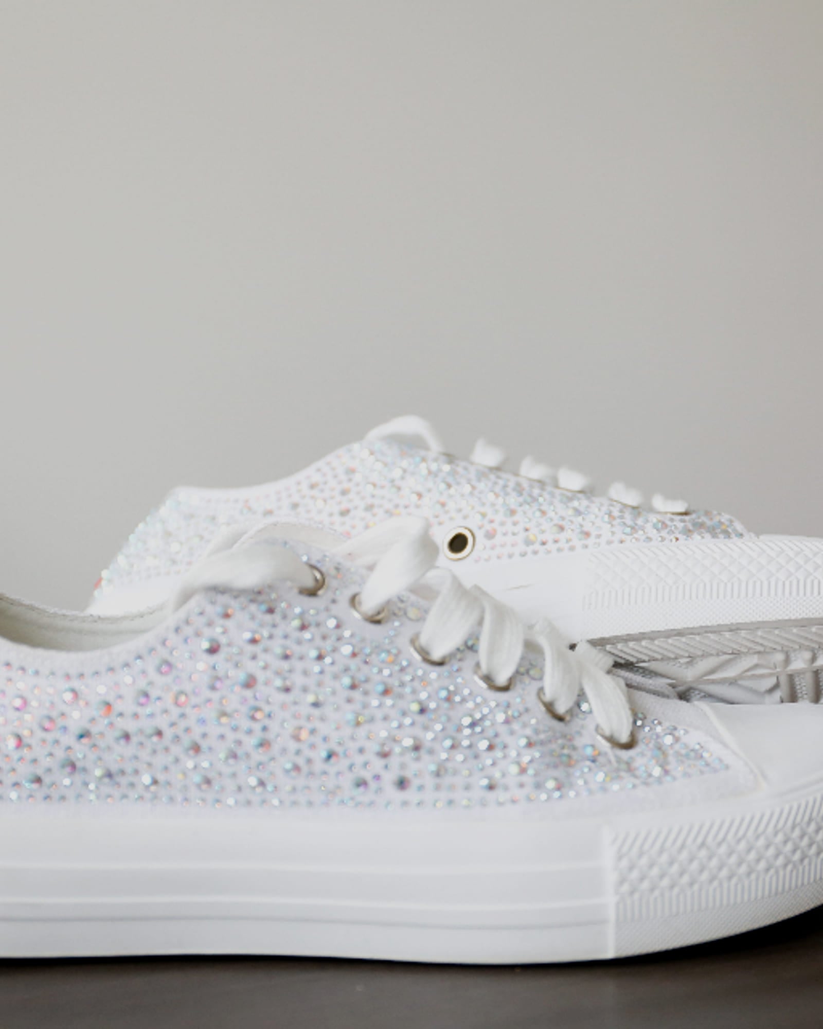White low-top sneaker on a pale background — detail view