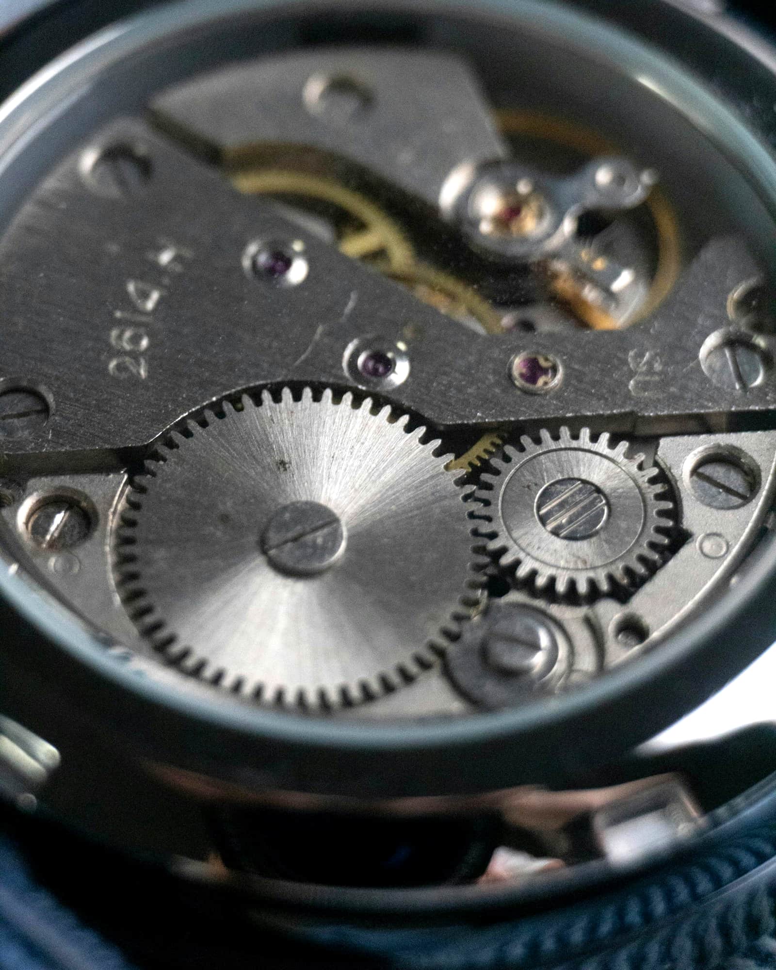 Macro view of a mechanical watch movement, gears and bridges in steel