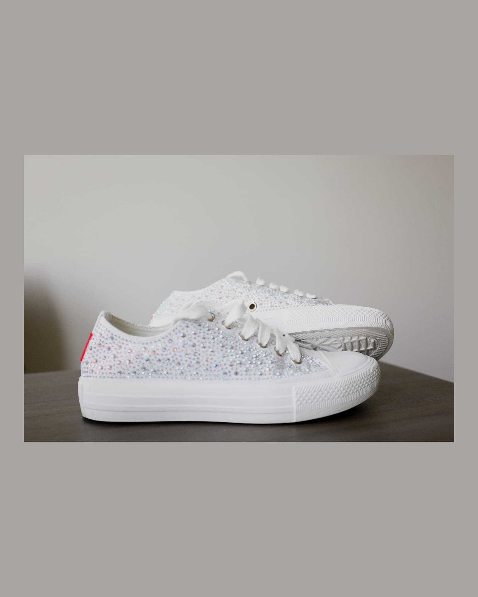 White low-top sneaker on a pale background